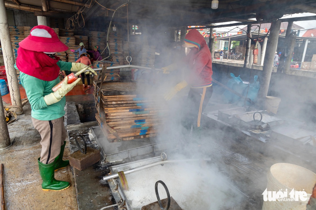 Nghề hấp cá vào vụ- Ảnh 3. Cá được cho vào lò hấp, nhân công làm việc trong môi trường nóng nực